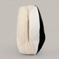 Load image into Gallery viewer, The Cocoon on its side with the bouclé cover partly unzipped to show the inner liner
